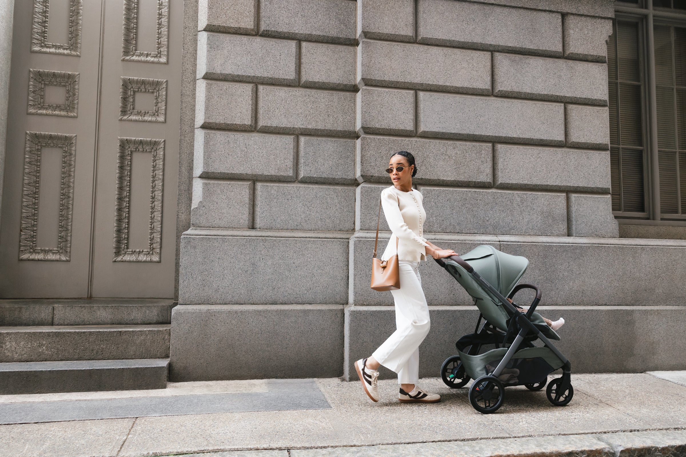 A parent walking with the UPPAbaby Kona stroller in Evelyn