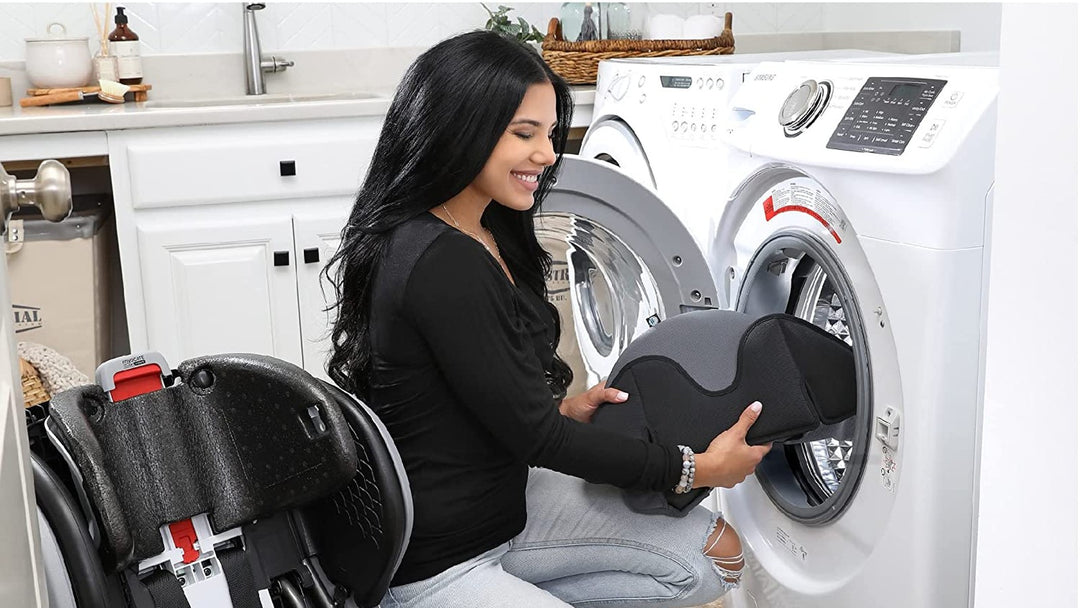 Parent cleaning car seat fabric in laundry room
