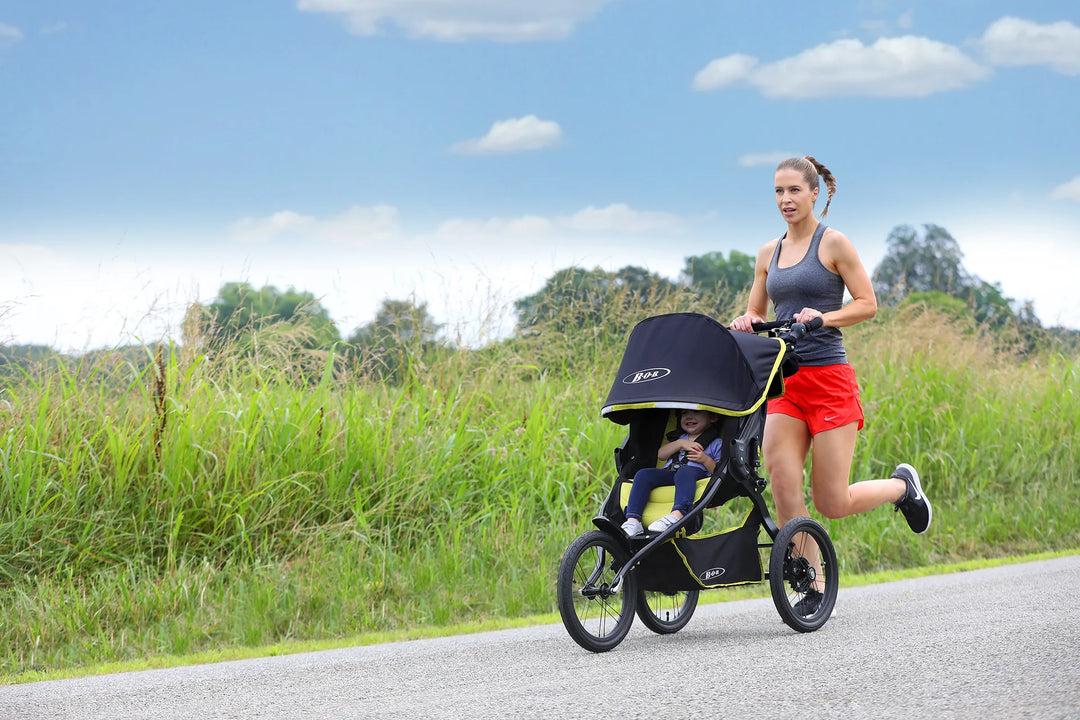 BOB Blaze Citron fixed-wheel stroller on a paved running path