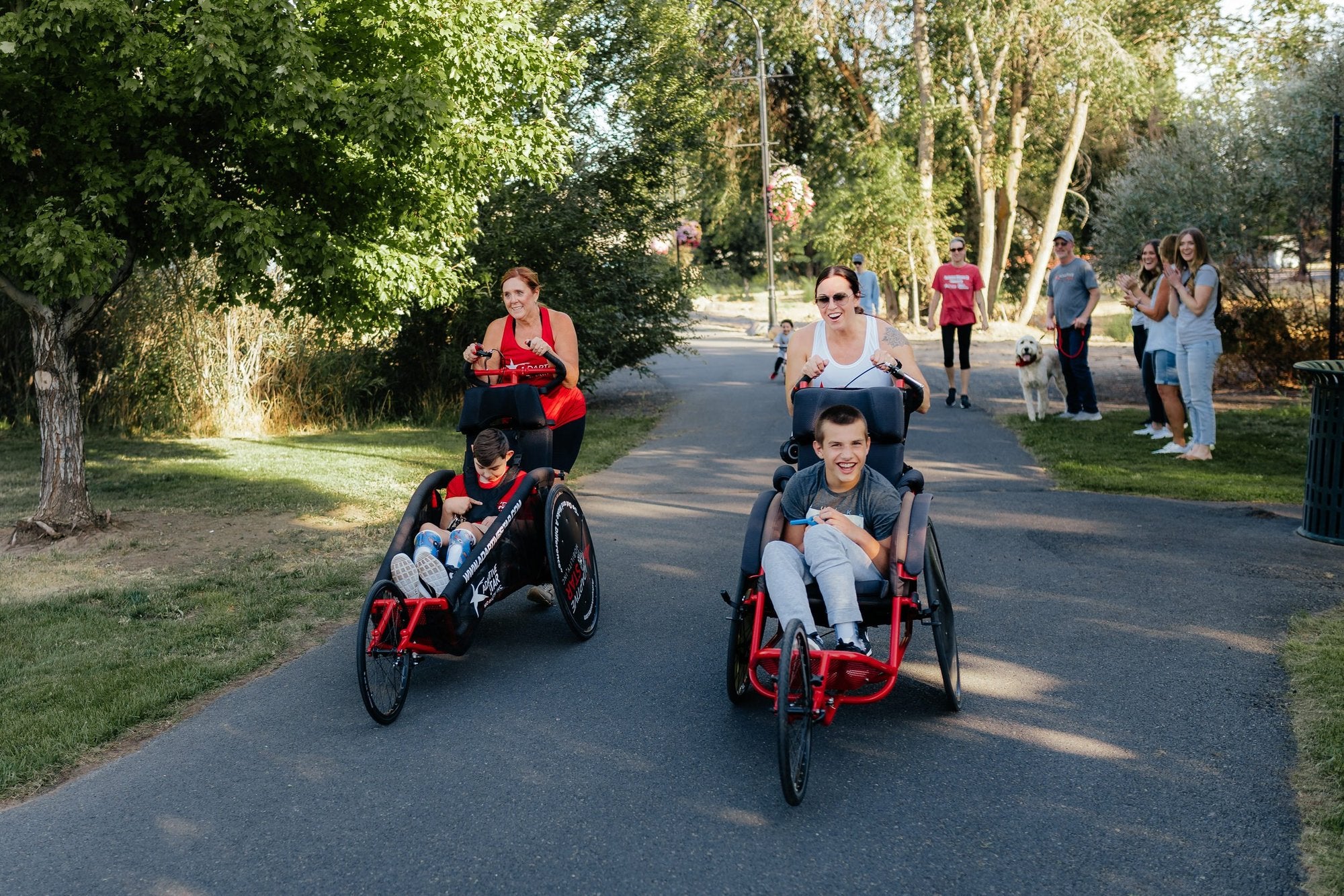 A family out together, a child riding in an adaptive push chair