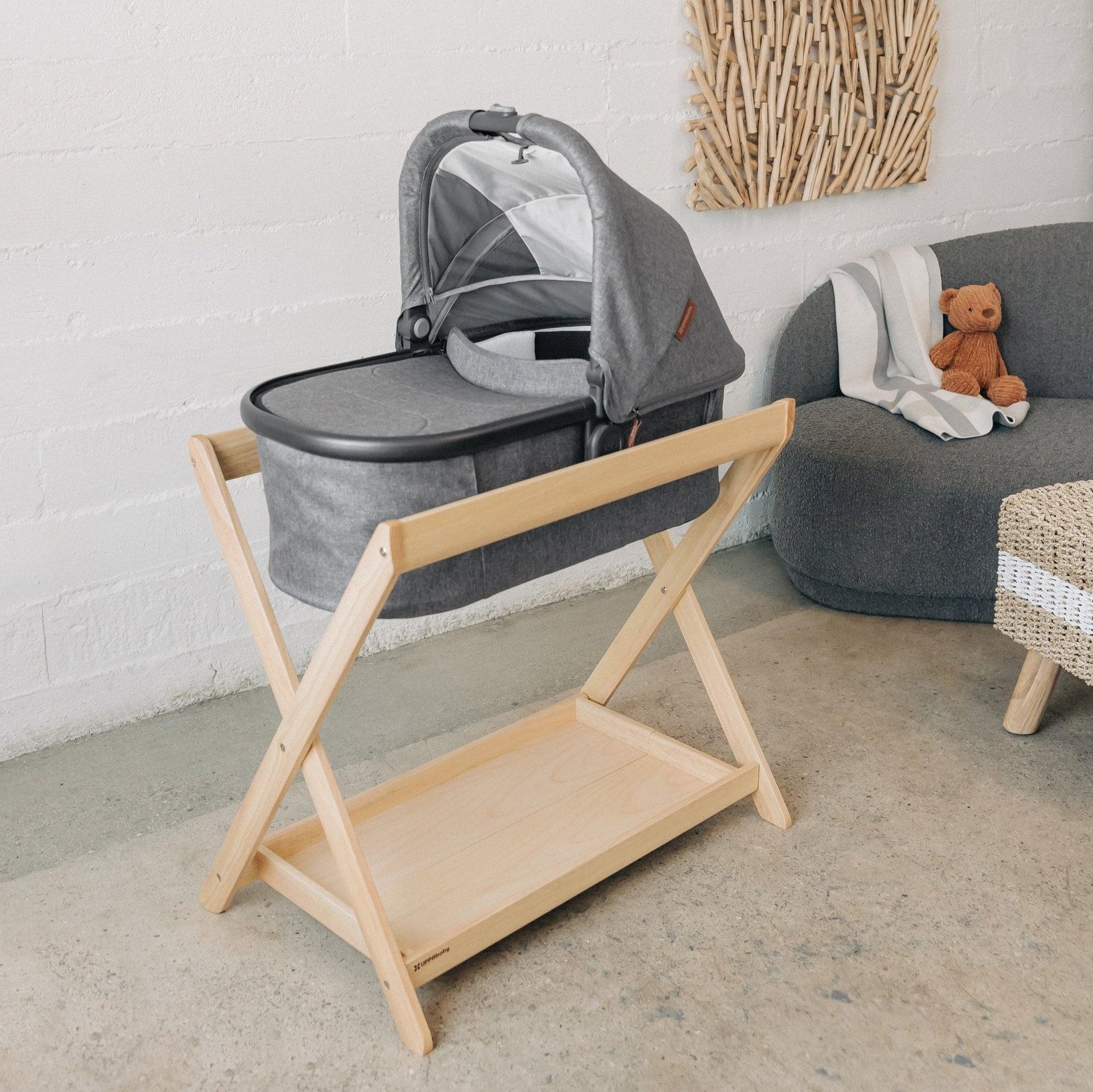 Bassinet on a natural wood stand in a calm nursery