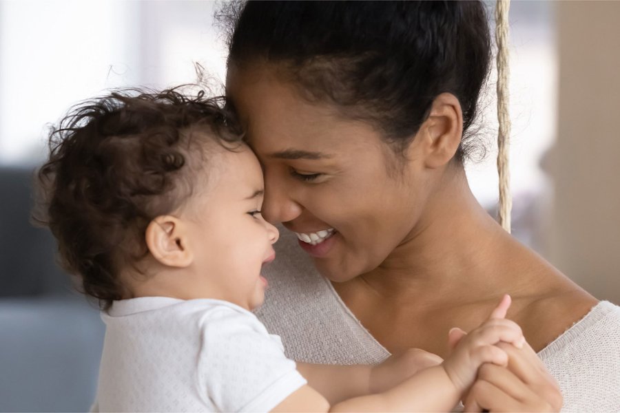 Mother holding her baby at home