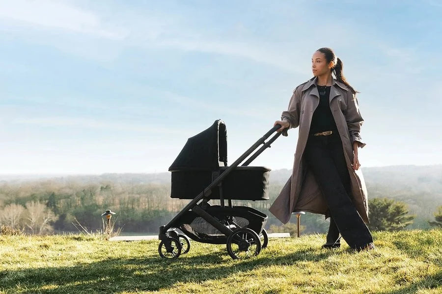 Mother walking with a premium stroller and bassinet