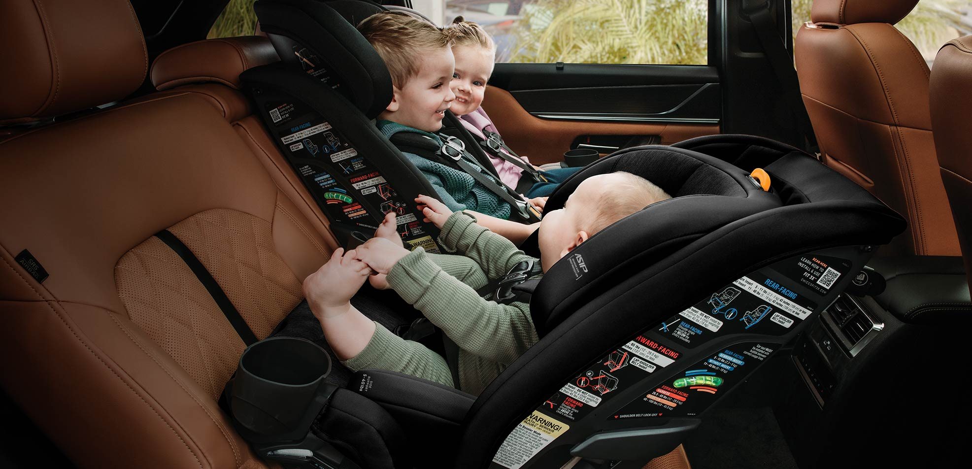 Two children riding in Chicco ClearTex car seats