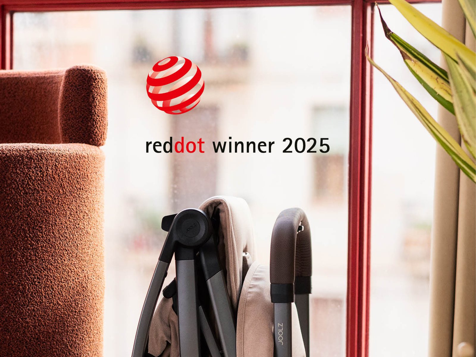 Folded Joolz Aer2 standing by a sunlit window, Red Dot winner 2025